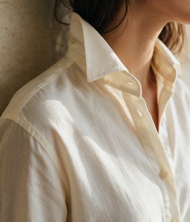 Woman wearing a crisp cream button-through cotton shirt — Legacy London womenswear