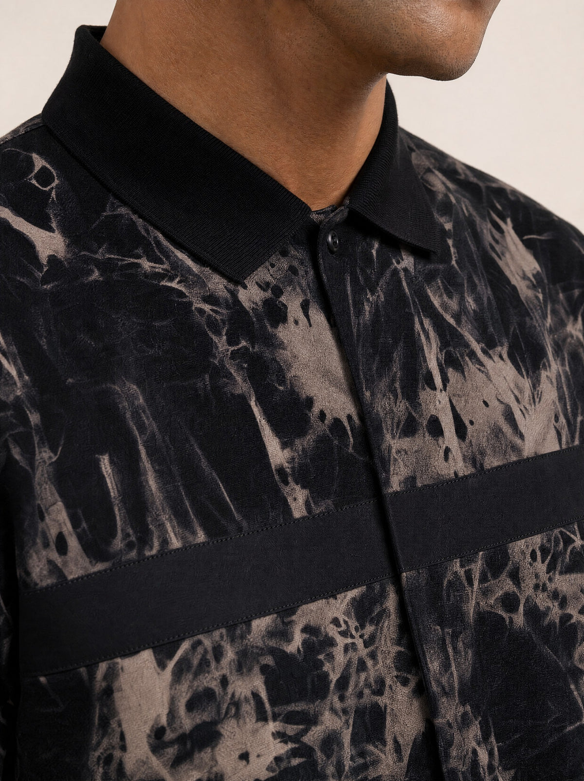 Close-up of the black collar, placket and chest tape on the Steel Gray overshirt