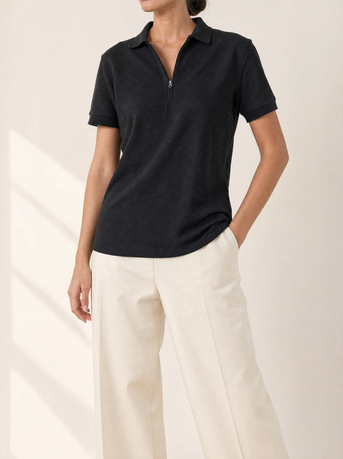 Luna Zip-front Polo Shirt in Black, front view - Legacy London